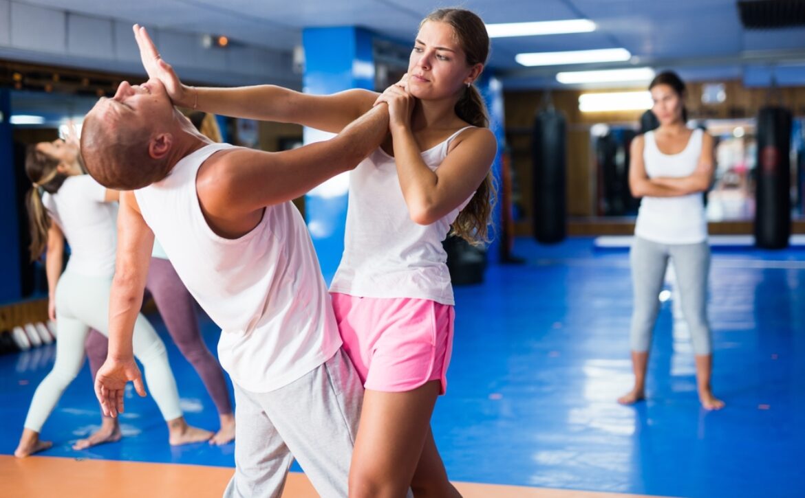 Young,Lady,Doing,Heel,Palm,Chin,Strike,During,Group,Self-defence